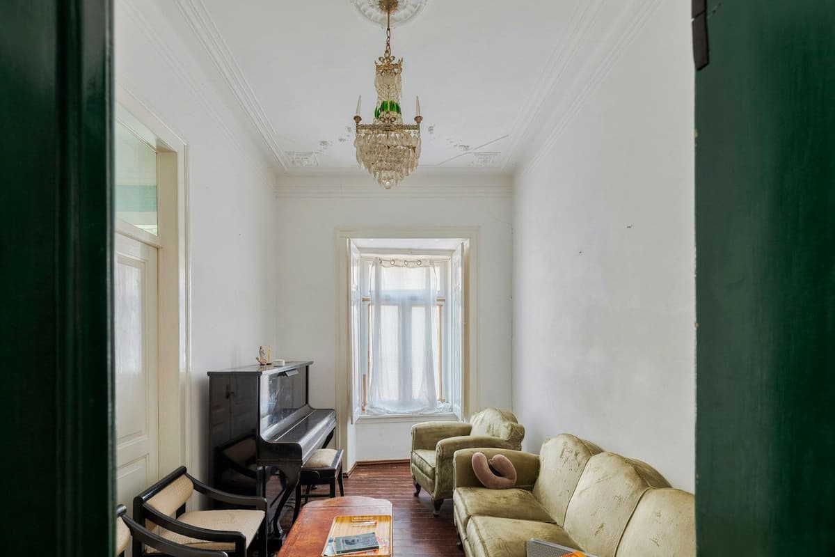 A living room with a piano and sofa